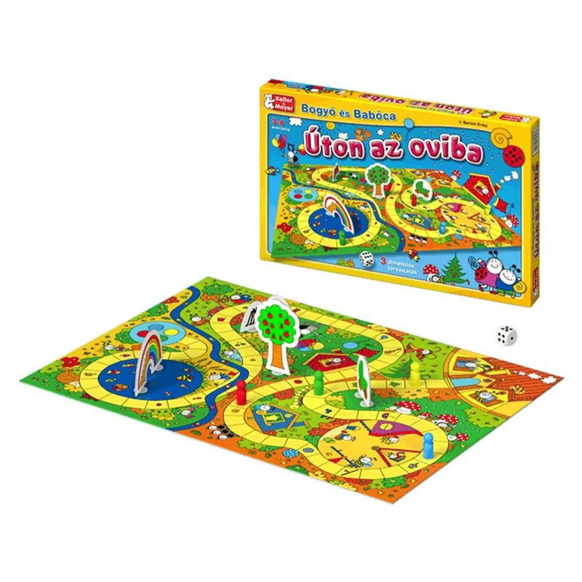 A Bogyó és Babóca: Úton az oviba társasjáték színes, kihajtott játéktáblája 3D elemekkel, bábukkal, fával és szivárvánnyal, mellette a doboz is látható.