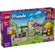 LEGO Friends: Botanikus kávéház és virágbolt (42671) dobozkép, a színes kávézóval, virágbolttal, villamossal és minifigurákkal zöld parkos háttérben.