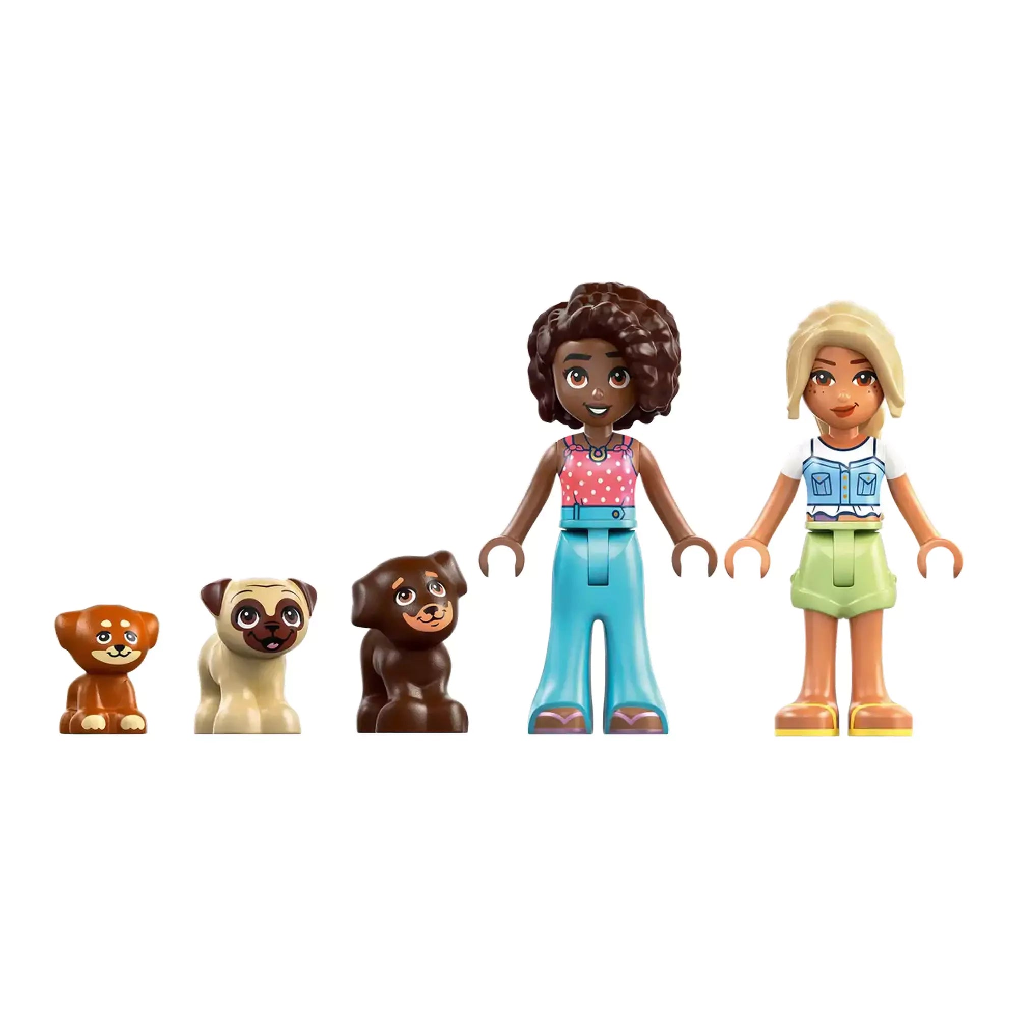 Közelkép a LEGO Friends Puppy Playground (42665) készlet karaktereiről: két barátságos minifigura és három aranyos kiskutya.