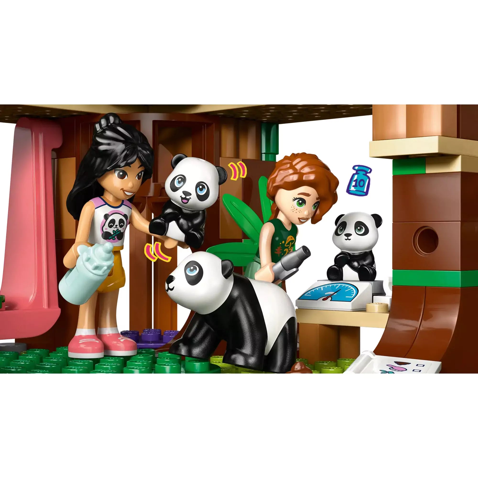 A két figura gondoskodik a pandákról a LEGO Friends Panda Menedékhely (42648) épület földszintjén, súlymérővel, cumisüveggel és szeretetteljes hangulattal.