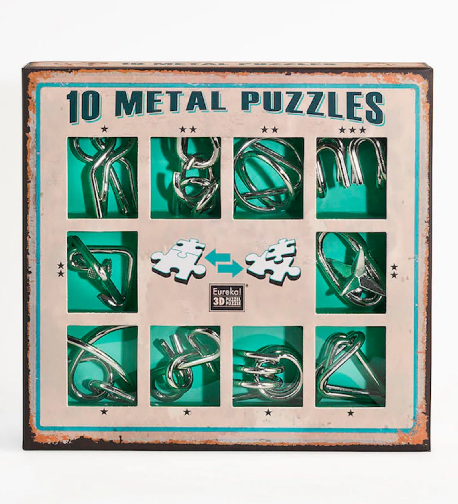 A 10 Metal Puzzle Set zöld változatának doboza elölről fotózva, amelyen tíz különböző fémből készült kirakó látható zöld háttérrel, rusztikus stílusú keretben, középen a „Eureka! 3D Puzzle” logóval.