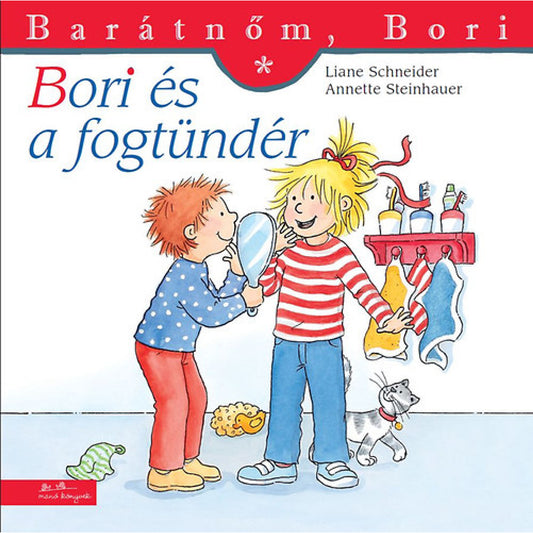 „Bori és a fogtündér” borító – Bori és egy kisfiú mosolyogva állnak a fürdőszobában. A fiú egy tükröt tart a kezében, miközben Bori érdeklődve nézi. A háttérben színes törölközők lógnak, a padlón egy kis játékcica játszik, a jelenet kedves és otthonos hangulatot áraszt.