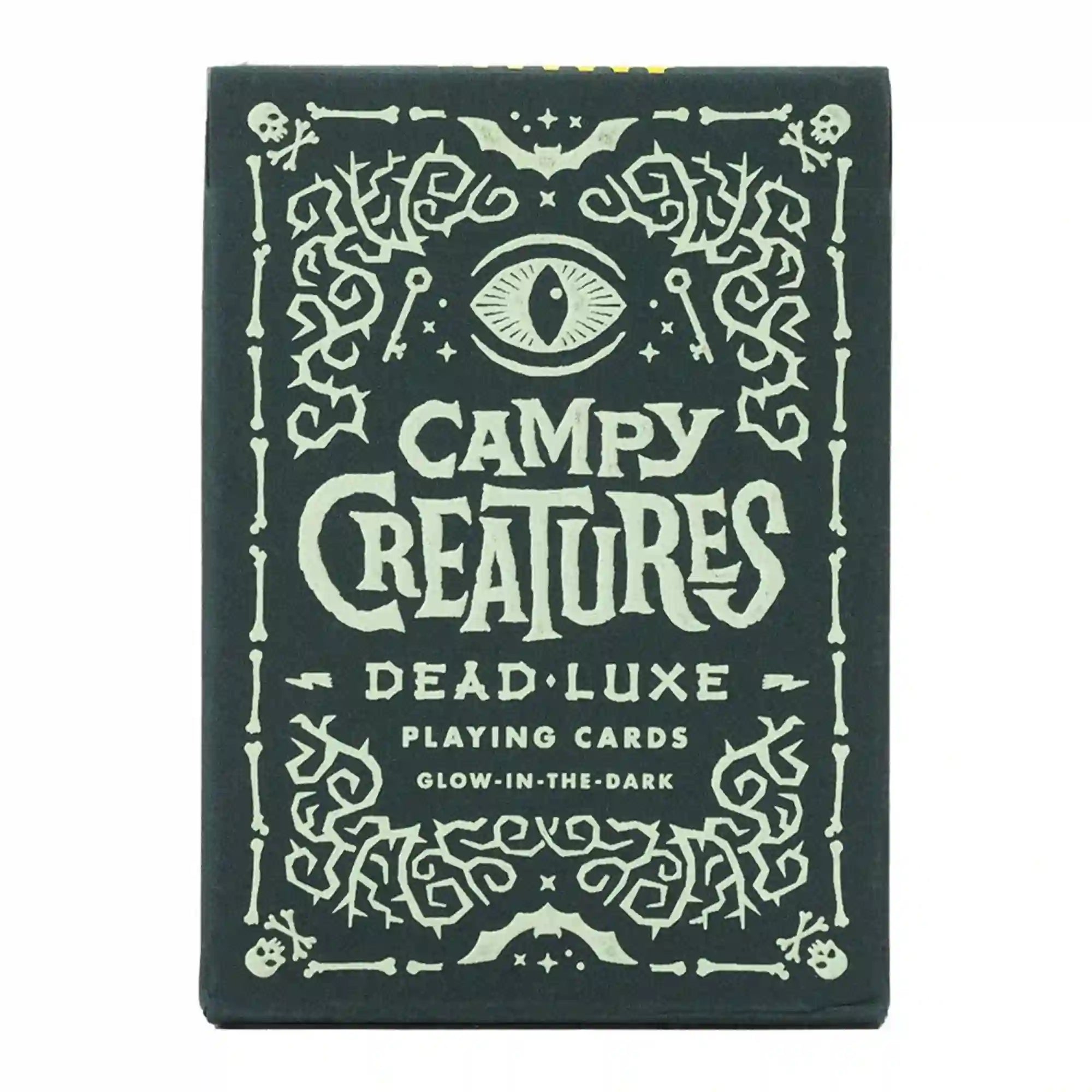 Campy Creatures Dead Luxe playing cards doboz, sötét alapon világító hatású díszítéssel, koponya- és szemmotívumokkal.