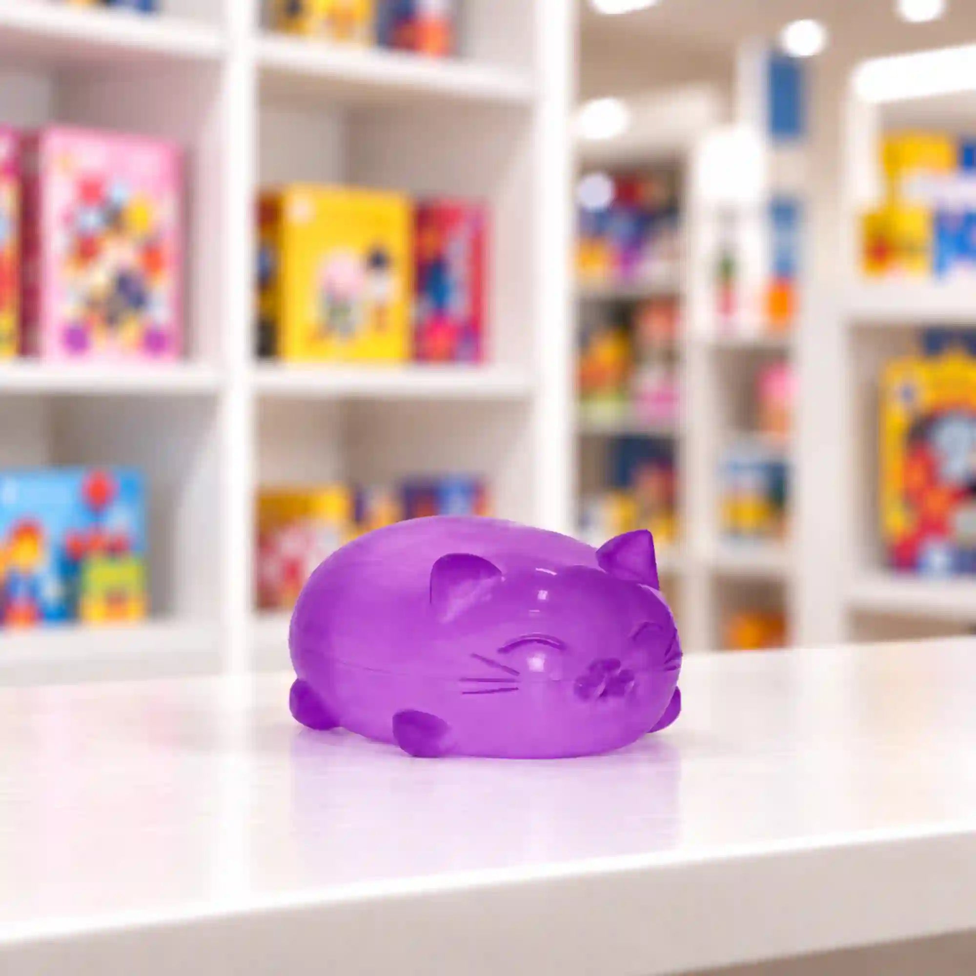 Cool Mix Super Gel lila cica stresszlevezető játék – áttetsző zselés macskafigura fehér asztalon, játékbolti környezetben