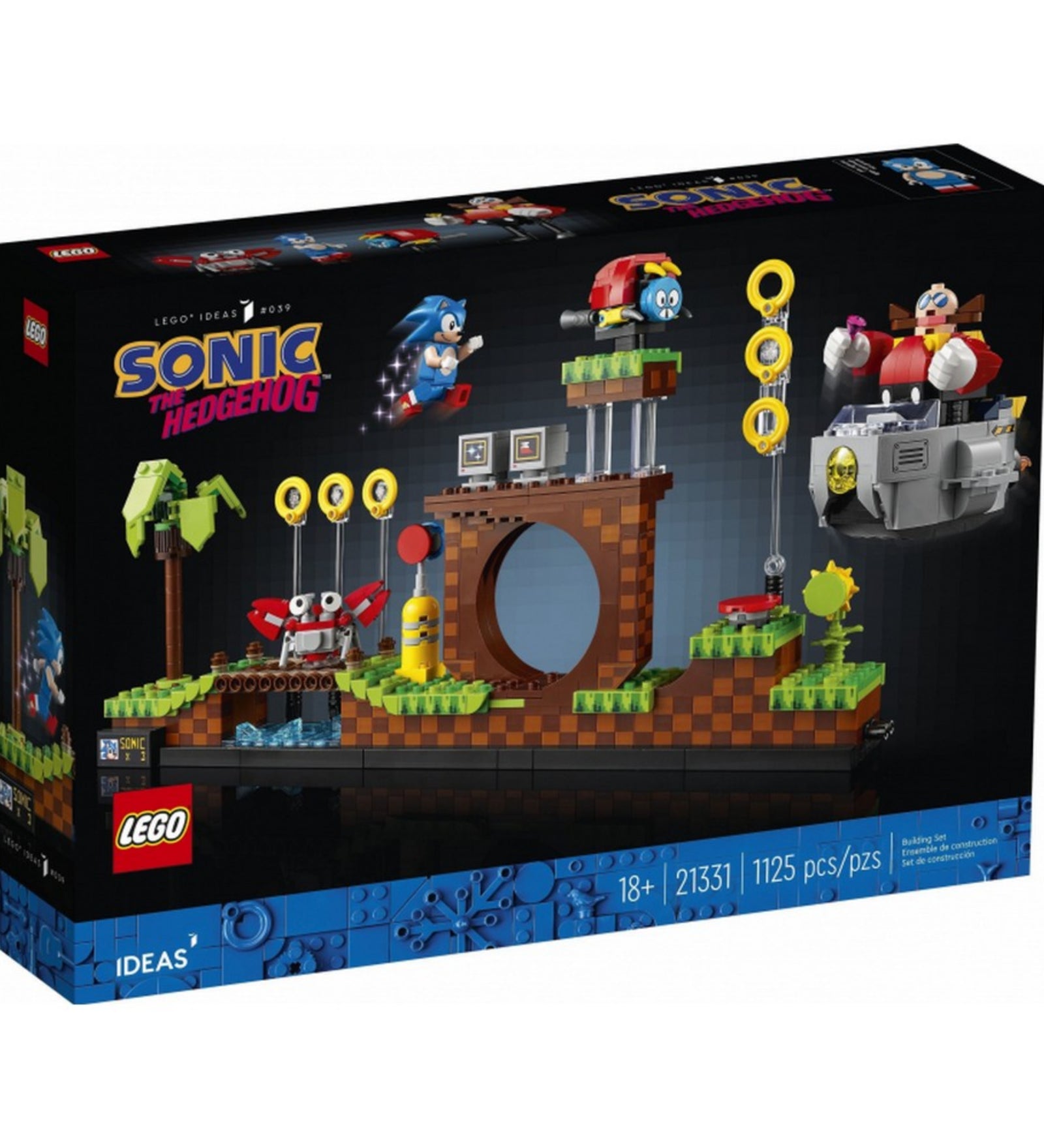  A LEGO Ideas Sonic the Hedgehog – Green Hill Zone (21331) készlet hivatalos doboza, sötét háttérrel, amely bemutatja az összeépített pályát, Sonicot, a gyűrűket, és Dr. Eggmant a repülő járművében.