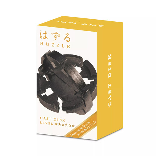 Huzzle Cast Disk logikai játék doboza, fehér-sárga dizájnnal és a fekete fém puzzle képével az elején.
