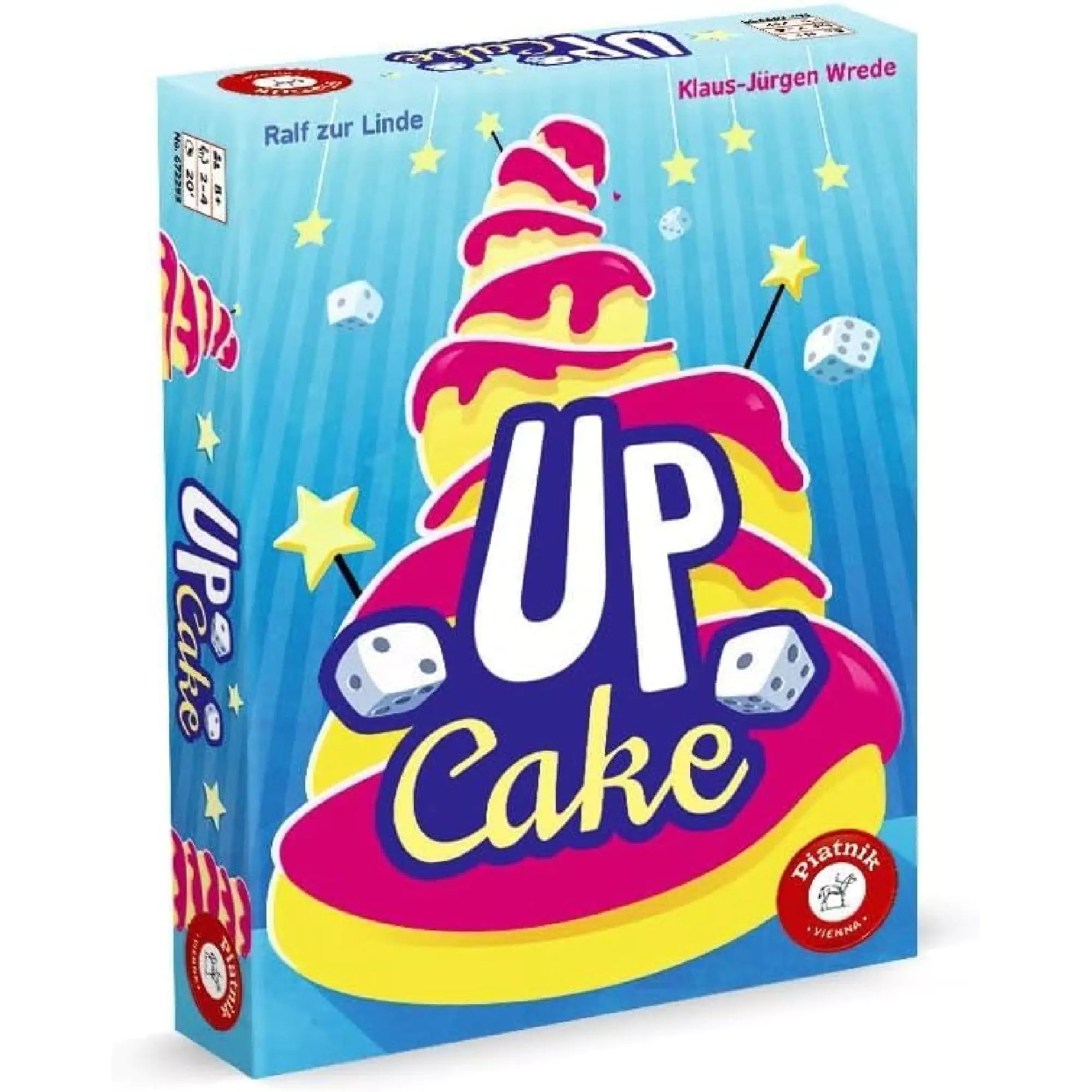 Az Up Cake társasjáték színes, vidám doboza, amely egy emeletes tortát ábrázol csillagokkal és dobókockákkal díszítve.