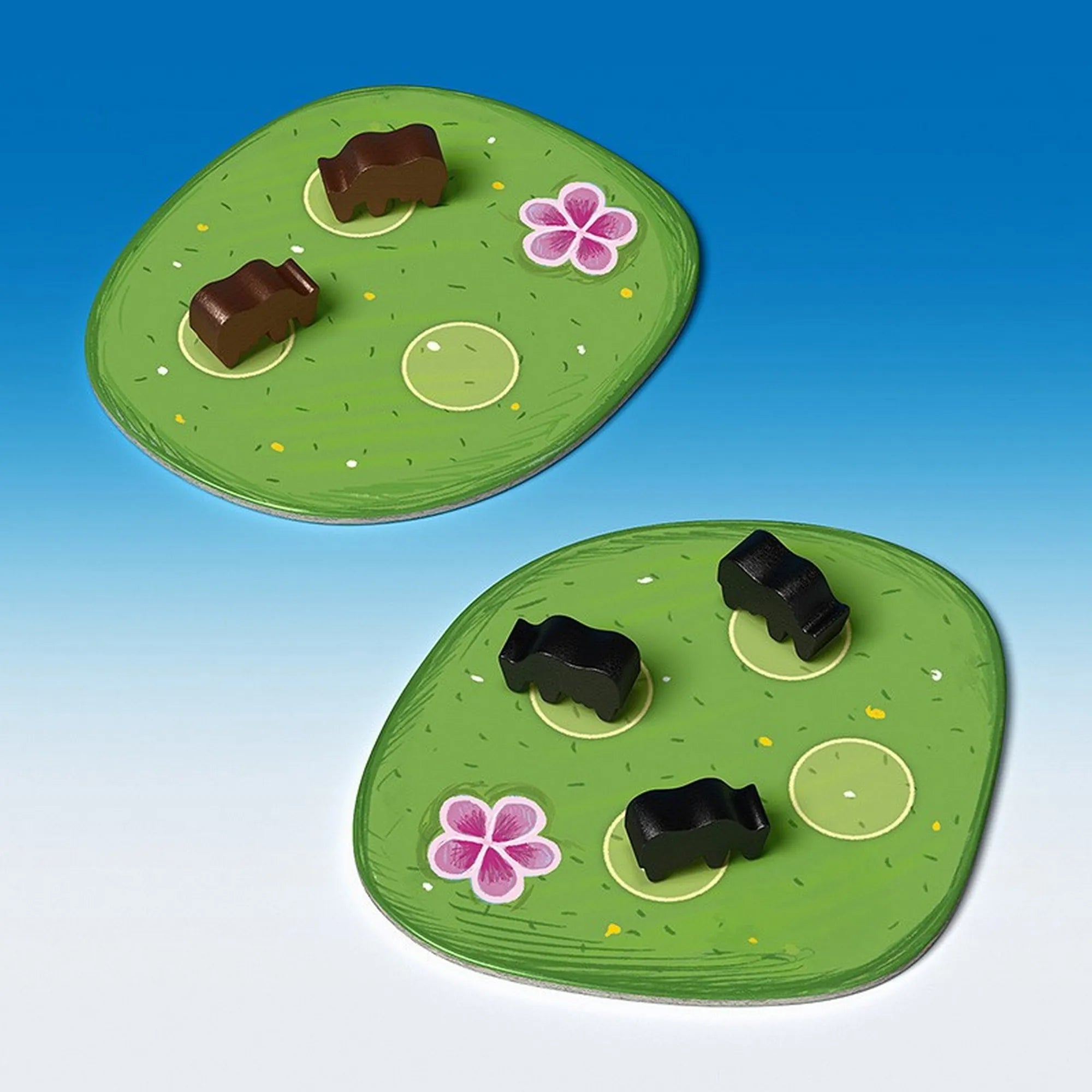 A Bociterelgető játék zöld legelőlapkái barna és fekete fa bocikkal, virágmintás mezőkön.