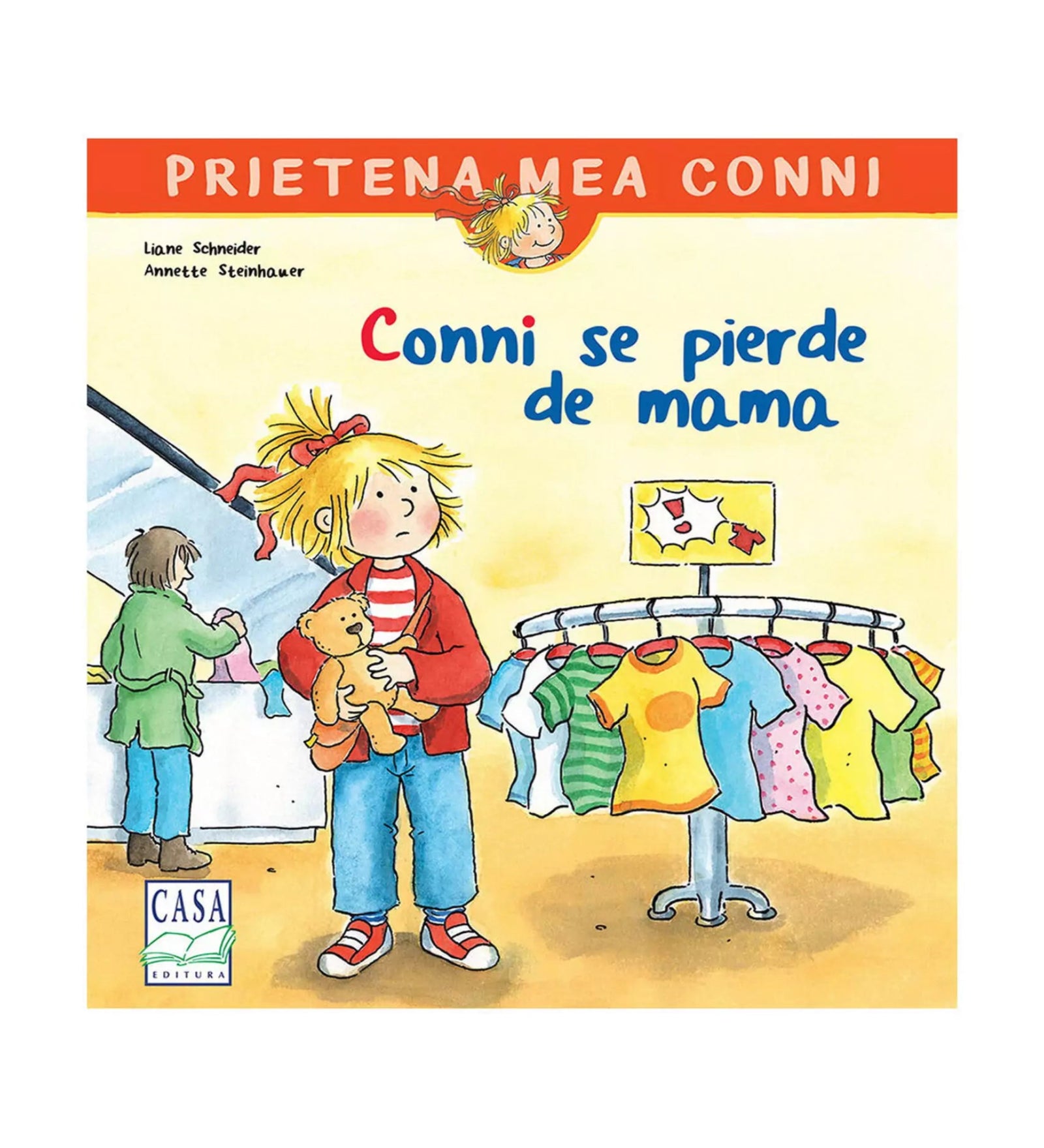 A kép a „Conni se pierde de mama” című gyerekkönyv borítóját ábrázolja. A rajzon Conni egy plüssmackót szorongatva áll egy ruhaboltban, mellette színes pólók lógnak egy állványon, a háttérben egy felnőtt alak látható a pénztárnál.