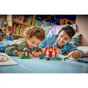 Gyerek és felnőtt együtt játszik LEGO Toy Story Blaze lovardájával, családi közös játékélmény és figurák használata