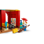 Jessie minifigura istállóban, kiegészítők: villa, széna, malac és díszített falrészlet LEGO Toy Story készletből