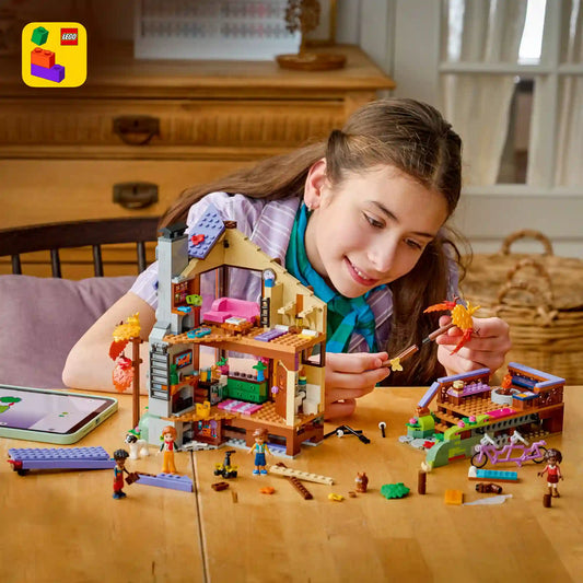 Gyermek építi a LEGO Friends erdei kabint, miközben a LEGO Builder alkalmazás digitális 3D-s építési útmutatóját használja.