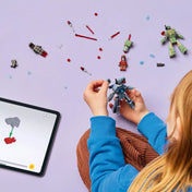 LEGO Marvel Super Heroes: Vasember és Hadigép vs. Hammer-drónok (76320) készlet játék közben, gyermek kézben tartja az egyik drónt.