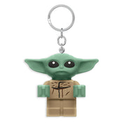 A LEGO Star Wars: A Mandalóri – Baby Yoda LED kulcstartó aranyos, zöld fejű és nagy fülű minifigura formában, fémszínű kulcskarikával.