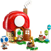 LEGO Super Mario: Buli Toad házában (72041) gombaház és figurák közelről – A nyitható ajtajú ház előtt álló kék és zöld Toad figurák.