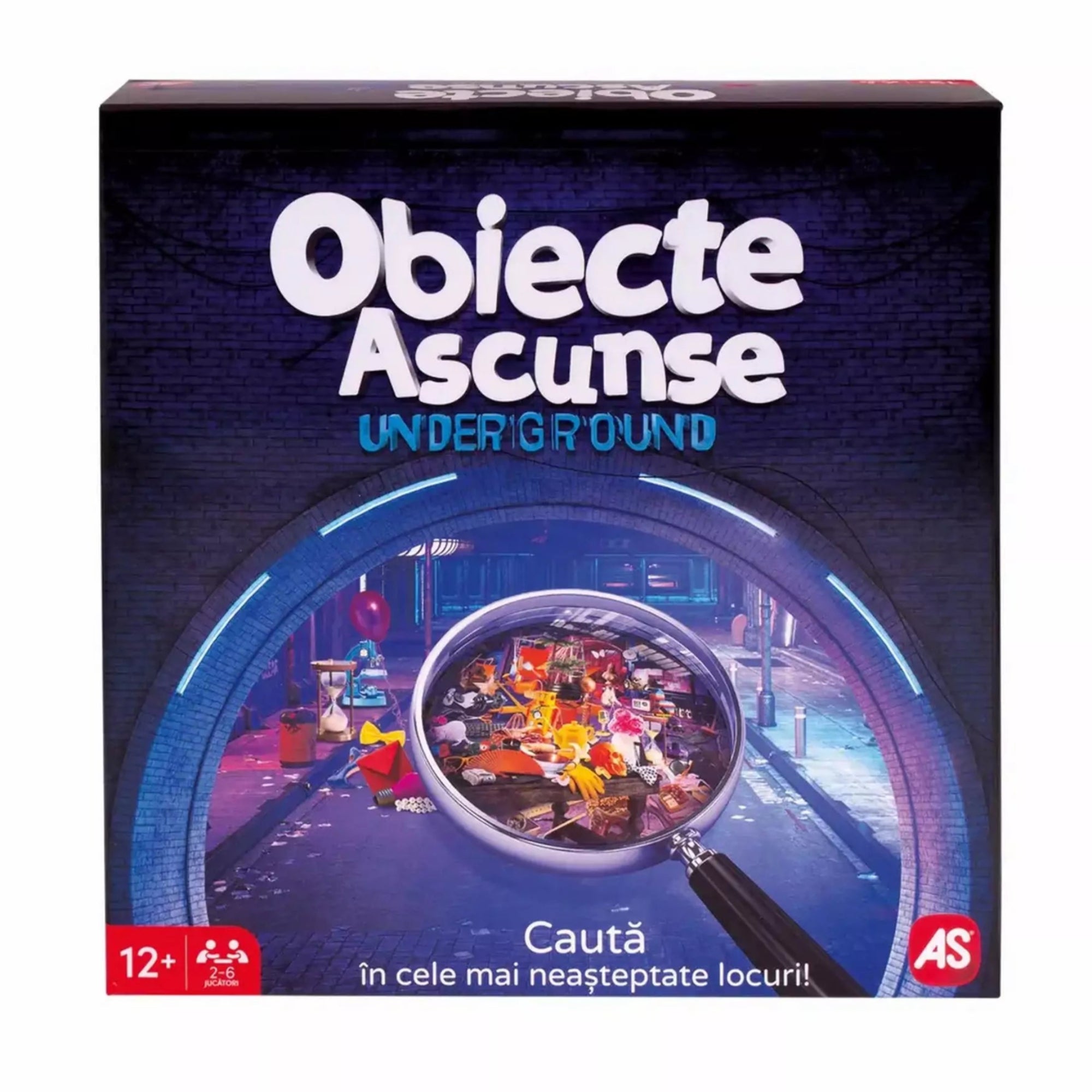 A „Obiecte Ascunse Underground” társasjáték doboza sötétkék háttérrel, középen egy nagyítóval, amely színes tárgyak tengerét emeli ki egy metróállomás hangulatú helyszínen.