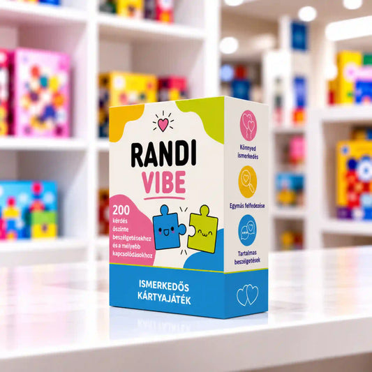 Randi Vibe ismerkedős kártyajáték színes, kék-rózsaszín doboza egy fehér asztalon, a háttérben elmosódott, színes játékbolti polcokkal.