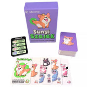 A Sunyi szelek társasjáték tartalma: játékkártyák színes állatfigurákkal (kutya, borz, tehén, fóka), valamint egy „Pukimérő” segédkártya. A lila doboz mellett a kártyapakli is látható